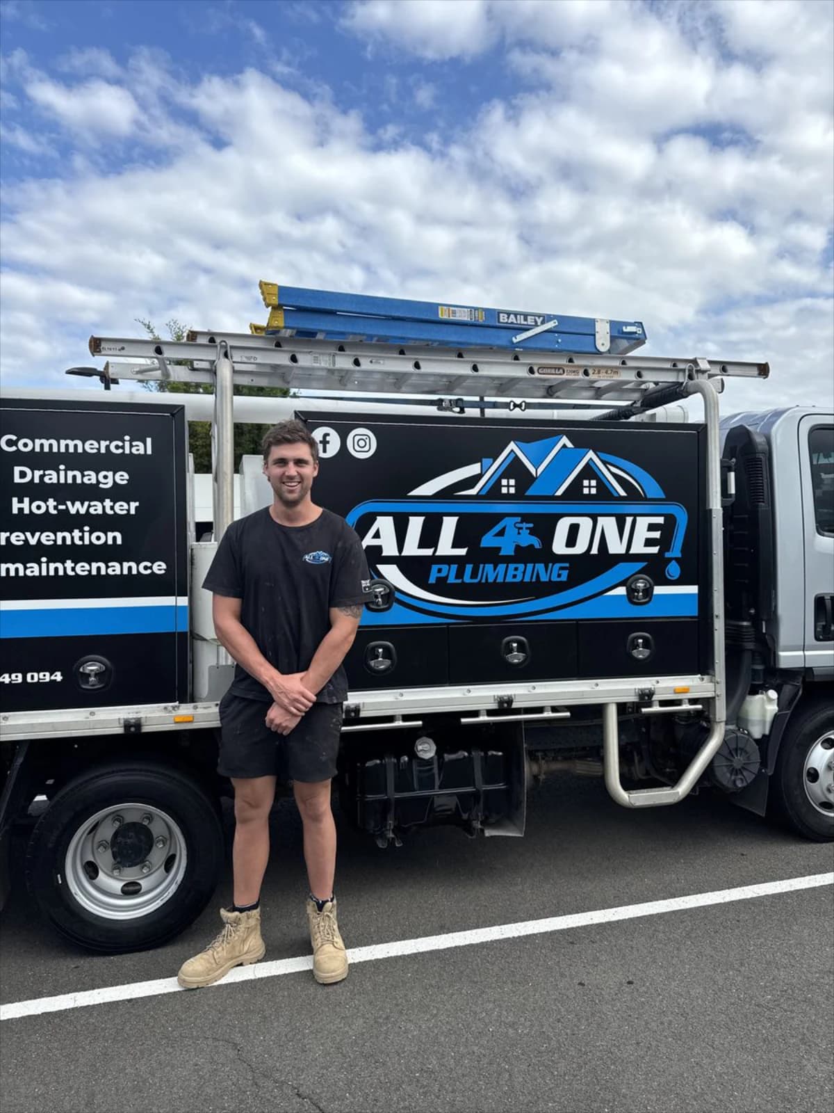 Josh from Plumber Western Sydney smiling beside a branded work vehicle