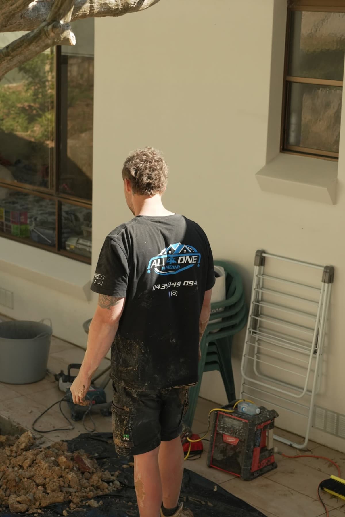 Josh covered in mud after a tough drain repair